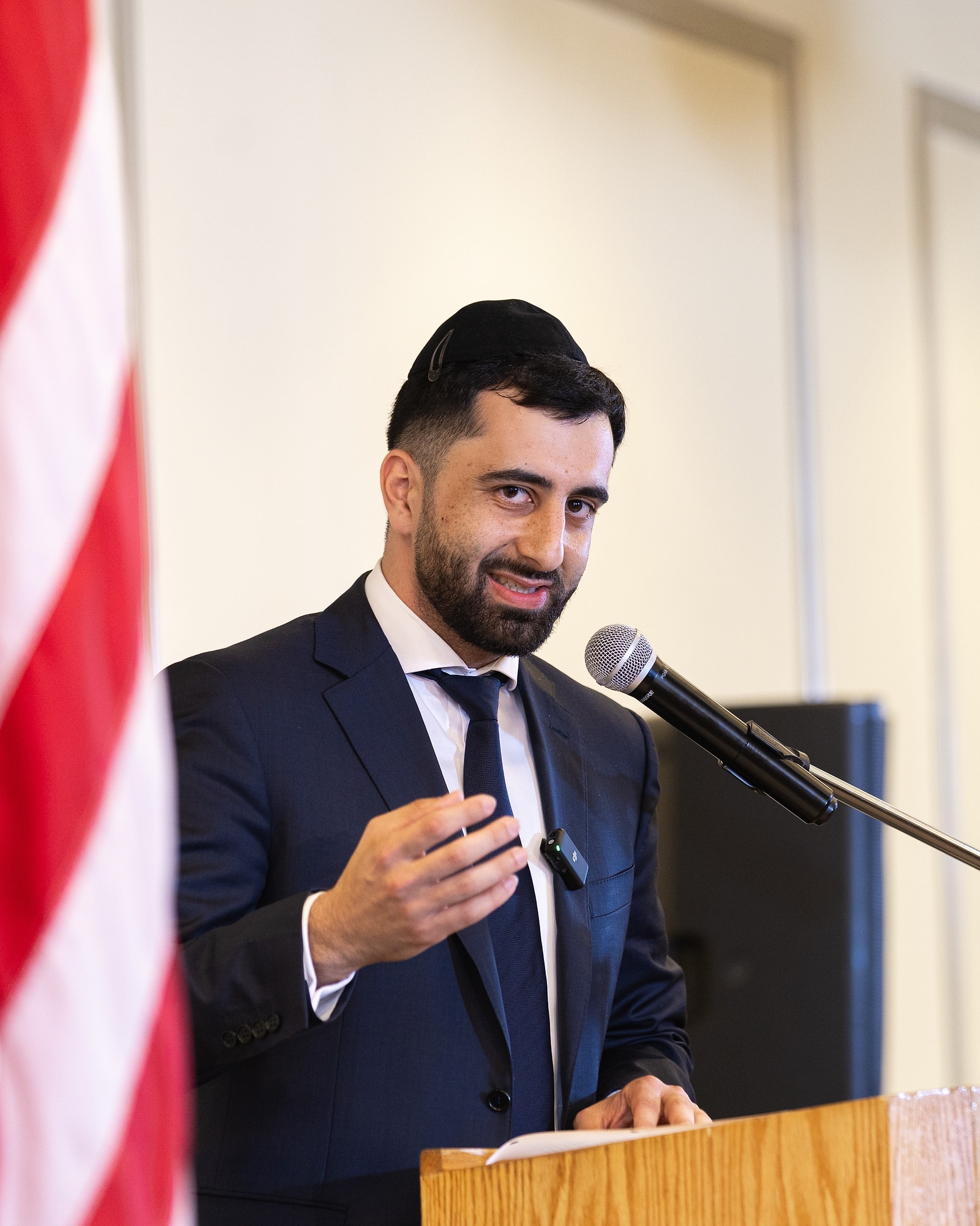 Bechor Mosheyev speaking at a podium